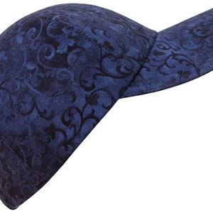 May include: A blue baseball cap with a black floral pattern.