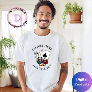 May include: White t-shirt with the text "I'M JUST HERE FOR THE POT" and a graphic of playing cards and poker chips. The shirt features a design with four playing cards and stacks of poker chips in various colors.