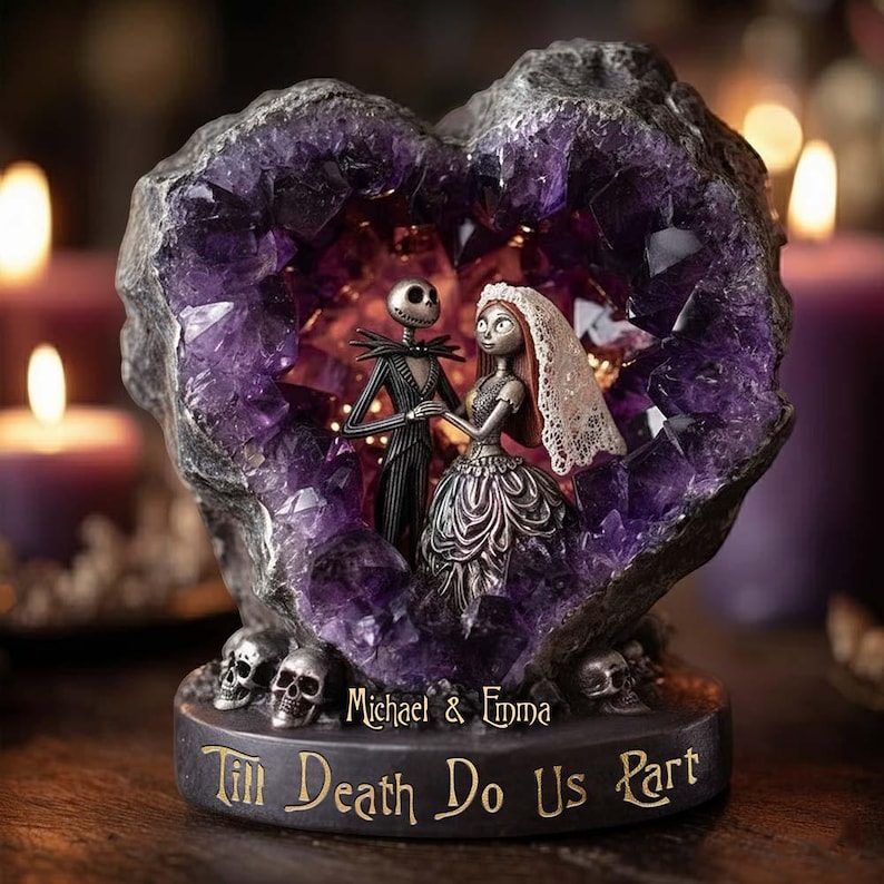 May include: A decorative heart-shaped sculpture featuring Jack Skellington and Sally from The Nightmare Before Christmas. The figures are inside a purple crystal geode. The base has the text "Till Death Do Us Part" and the names "Michael & Emma".