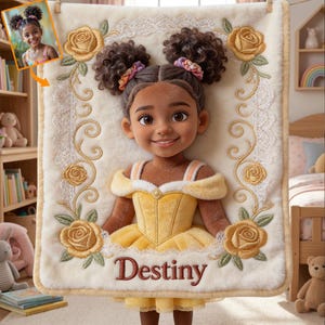 May include: A plush, cream-colored blanket featuring a cartoon illustration of a girl in a yellow dress, with the name "Destiny" embroidered in a burgundy script. The blanket is decorated with embroidered yellow roses and a lace border.