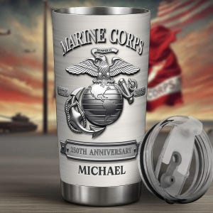 May include: A stainless steel tumbler with a lid, featuring a Marine Corps emblem with an eagle, globe, and anchor design. The tumbler commemorates the 250th anniversary and has the name "MICHAEL" on it.