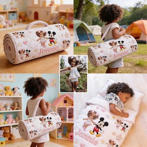 May include: A rolled-up, quilted sleeping bag with a handle, featuring embroidered images of Mickey Mouse and a girl character. The name "Jennie" is embroidered in pink. The sleeping bag is white with a diamond pattern and pink accents.