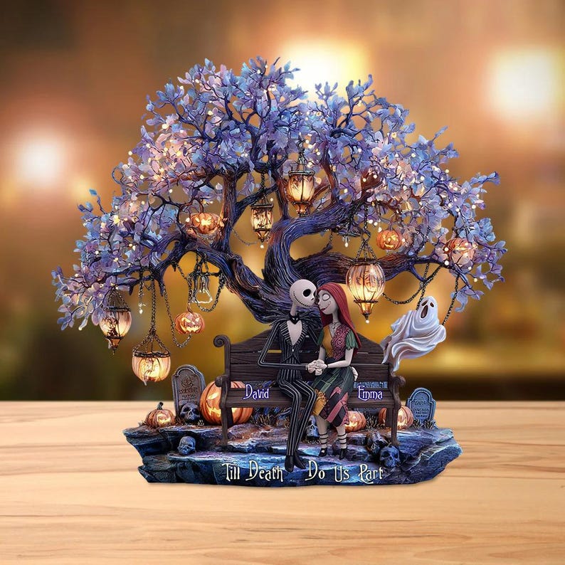 Puede incluir: Figura decorativa que representa a una pareja sentada en un banco bajo un &aacute;rbol con linternas y calabazas. El &aacute;rbol tiene hojas moradas y luces. La base incluye l&aacute;pidas y el texto "Till Death Do Us Part".