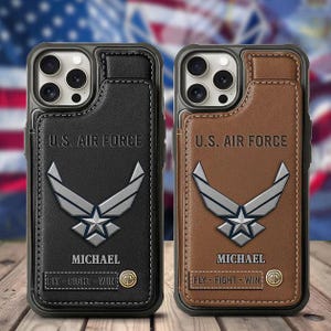 May include: Two phone cases, one black and one brown, featuring the U.S. Air Force emblem. Each case has the text "U.S. AIR FORCE" and the name "MICHAEL". The bottom of each case reads "FLY - FIGHT - WIN".