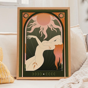 May include: A framed art print featuring a stylized illustration of a nude figure with flowing red hair, reaching towards a sunburst design. The artwork is set against a dark green background with decorative elements and a wooden frame.
