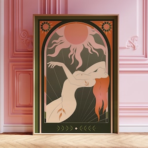 May include: A framed art print featuring a stylized illustration of a nude figure with flowing red hair, set against a dark green background. A peach-colored sun and decorative elements frame the figure. The artwork is in a wooden frame.