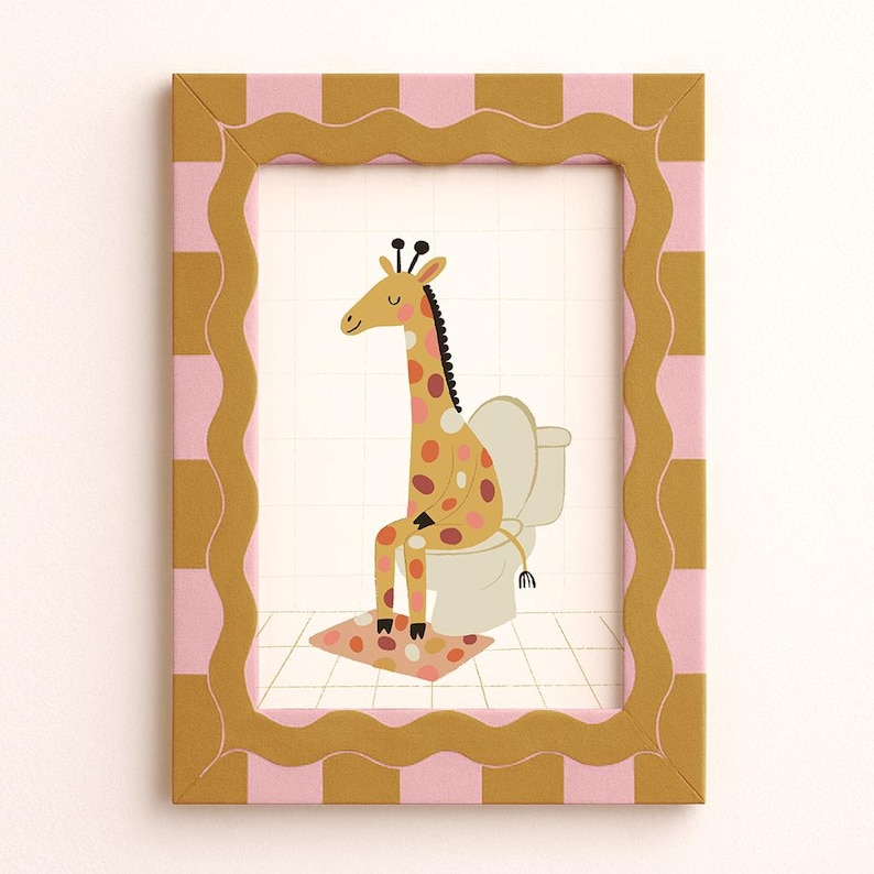 May include: A framed print featuring a giraffe sitting on a toilet. The giraffe has a yellow body with brown and pink spots. The frame is gold with a pink and gold checkered border. The giraffe is sitting on a white toilet with a pink and brown patterned rug.