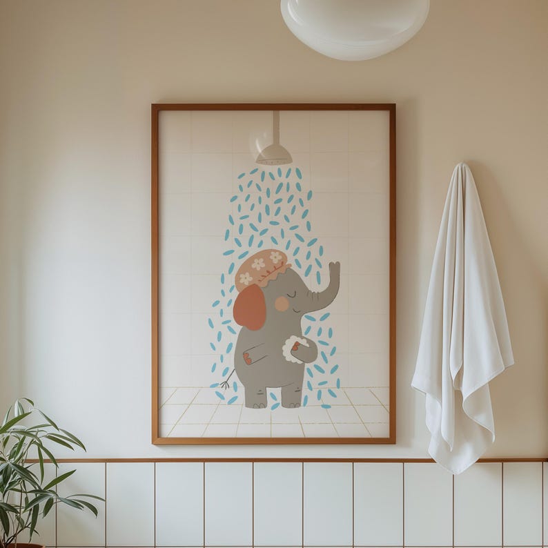May include: A framed print featuring a cartoon elephant taking a shower. The elephant is gray with orange ears and a floral shower cap. Blue water droplets fall from a showerhead. The print is in a brown wooden frame.