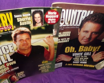 May include: Two copies of Country Weekly magazine featuring Vince Gill on the cover. The top magazine has a yellow headline that reads "Vince Gill In His Own Words". The bottom magazine has a yellow headline that reads "Oh, Baby! Vince Gill".