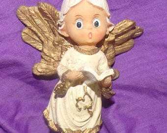 Ángel en miniatura vintage con cancionero de la era de 1960 Estatuilla