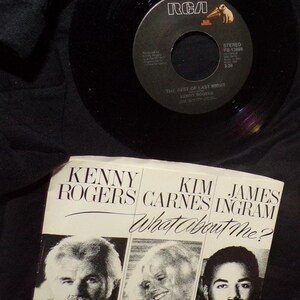 May include: A black vinyl record and its sleeve. The record label reads "THE BEST OF LAST NIGHT" by Kenny Rogers. The sleeve features Kenny Rogers, Kim Carnes, and James Ingram, with the title "What About Me?" printed on it.