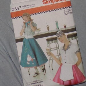 May include: Simplicity sewing pattern featuring a retro diner theme. The pattern includes images of a woman in a poodle skirt and a waitress in a uniform. The pattern size is HH, with sizes 6, 8, 10, and 12.
