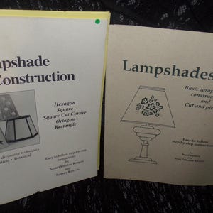 May include: Two instructional booklets on lampshade construction. The left booklet is titled "Lampshade Construction" and features diagrams of various lampshade shapes. The right booklet is titled "Lampshades" and shows a lamp illustration.