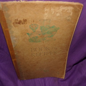 May include: A vintage book titled "Book of Recipes" with a green illustration of a bowl and pitcher on the front cover.