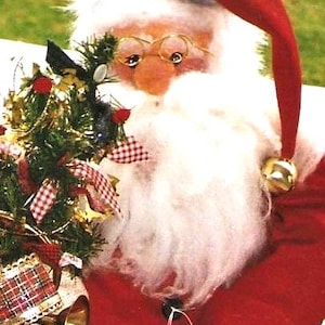 May include: A Santa Claus doll with a red hat and coat, white beard, and gold-rimmed glasses. The doll holds a small Christmas tree decorated with red and white checkered ribbons and gold bells. A festive holiday decoration.