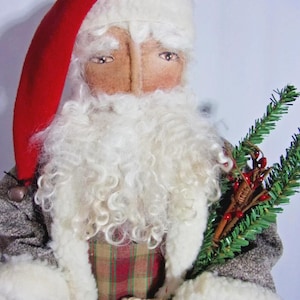 May include: A handcrafted Santa Claus doll with a red hat and a long white beard. The doll wears a gray coat with white trim and a plaid vest. It holds a lantern and a sprig of greenery, perfect for holiday decor.