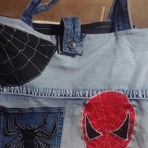 Button closure, custom handles, Spidey patches and a cool pocket on both sides of tote.