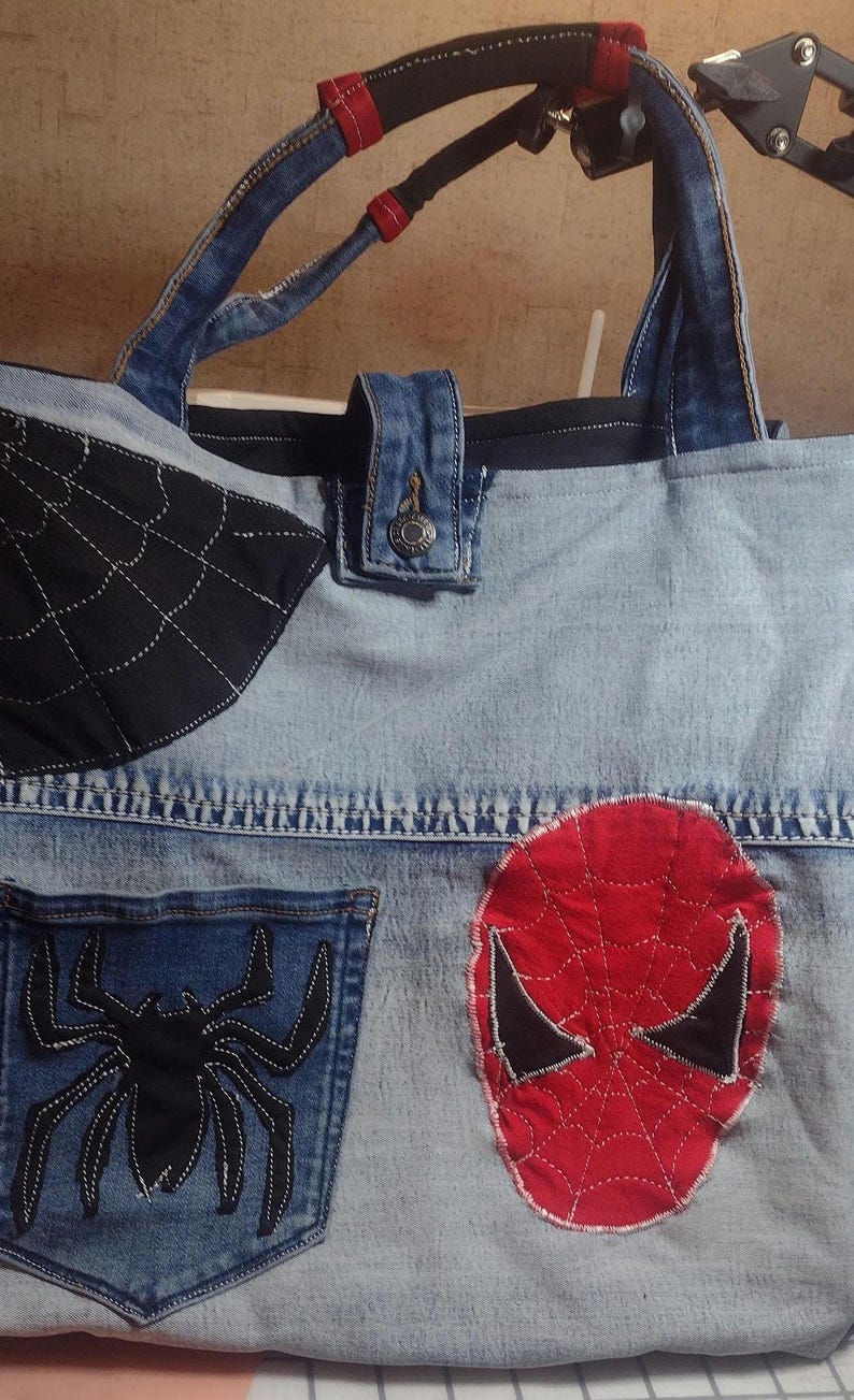 Button closure, custom handles, Spidey patches and a cool pocket on both sides of tote.