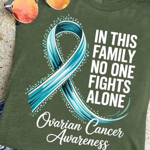 In This Family No One Fights Alone Shirt – Ovarian Cancer Awareness Tee – Ovarian Cancer Support Shirt – Inspirational Cancer Fighter Shirt