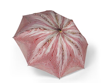 Paraguas óptico rojo y blanco, sombrilla de rayas abstractas, estampado geométrico moderno, accesorio de lluvia con efecto de ilusión óptica.
