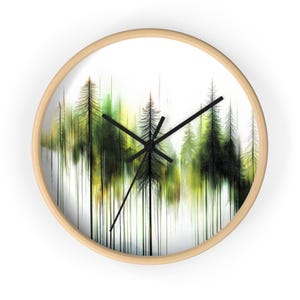 May include: A round wall clock with a wood frame and a white background. The clock face features a watercolor painting of a forest with green and brown trees.