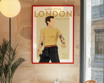 May include: A rectangular wall poster in a red frame featuring a stylized illustration of Harry Styles. The text reads HARRY STYLES LONDON NIGHT TWO WEMBLEY STADIUM 13.06.26. The figure wears a yellow striped shirt, black pants, and an orange belt.