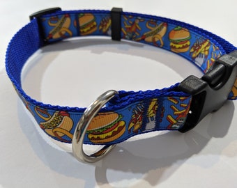 May include: Blue dog collar with a colorful print of hot dogs, hamburgers, and french fries. The collar has a black plastic buckle and a silver metal D-ring.