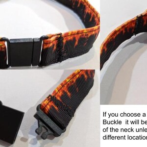 May include: A black breakaway buckle with a flame pattern. The buckle is attached to a black and orange fabric strap. If you choose a BLACK Breakaway Buckle it will be added to the back of the neck unless you request a different location.