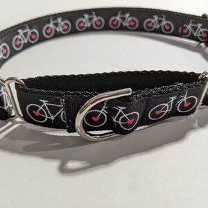 May include: Black dog collar with a white bicycle and red heart design.