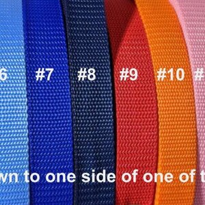 May include: A close-up of 15 different colored webbing straps. The straps are numbered 1 through 15. The text "The ribbon is sewn to one side of one of these straps." is at the bottom of the image.