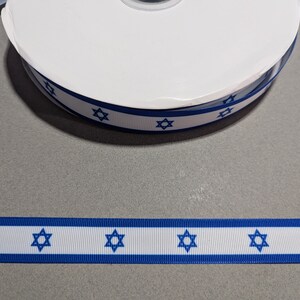 May include: White ribbon with blue stripes and blue Star of David symbols.