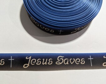 May include: A roll of blue and black ribbon with the text "Jesus Saves" and a cross printed in white.