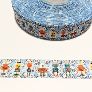 May include: Blue and white ribbon with a repeating pattern of robots and cogs. The robots are colourful and have different designs.