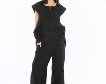 May include: A black wrap-style pantsuit with a square neckline top and short sleeves. The pants have a wide leg.