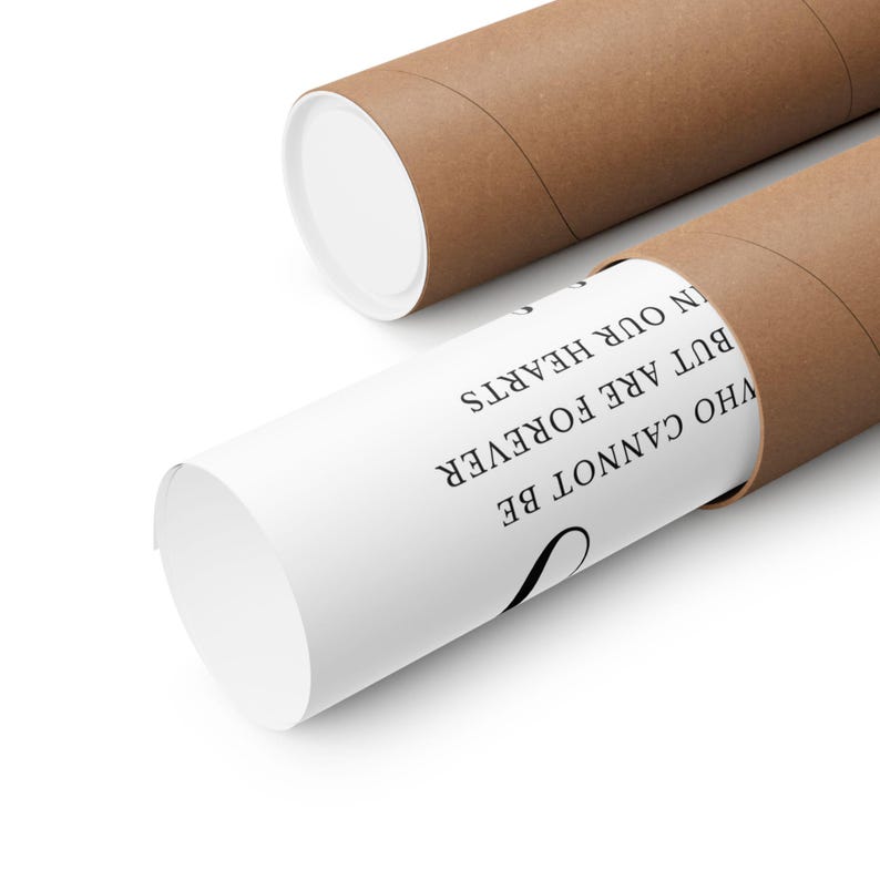 May include: A rolled-up white poster with black text inside a brown cardboard tube. The text reads "WHO CANNOT BE BUT ARE FOREVER IN OUR HEARTS". The tube is partially open, revealing the poster's message.
