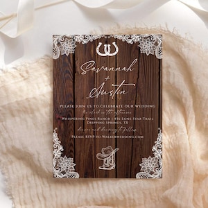 May include: Rustic wedding invitation with a wooden background and white floral lace accents. The invitation features the names "Savannah + Austin" in elegant script, along with event details and RSVP information.