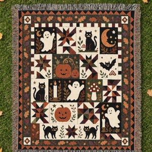 May include: A rectangular woven throw blanket featuring a patchwork design with Halloween motifs including black cats, white ghosts, orange pumpkins, bats, crescent moons, stars, and mushrooms, all framed by a border of autumn leaves and triangles.