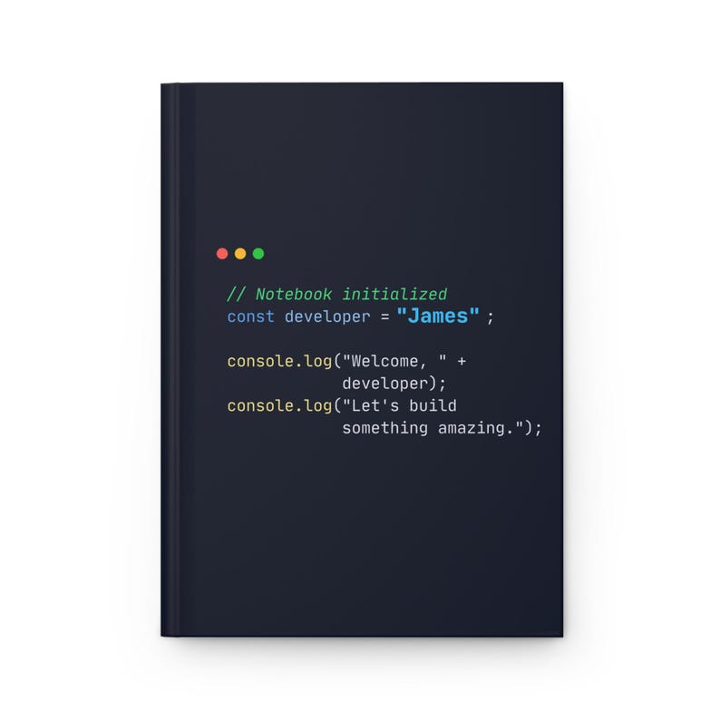 Puede incluir: Un cuaderno negro con texto blanco que dice "// Notebook initialized const developer = James; console.log("Welcome, " + developer); console.log("Let's build something amazing.")". El cuaderno tiene un dise&ntilde;o sencillo.