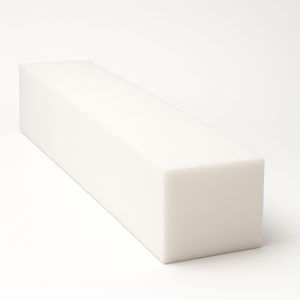 May include: A white foam block in a rectangular shape. The block is a solid, opaque white colour and has a smooth surface. The shape is a long, rectangular prism, suitable for crafting or construction. The block is set against a white background.