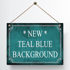 May include: A rectangular teal blue sign with white text that reads "* NEW * TEAL BLUE BACKGROUND". The sign is framed with a white border and decorative corner elements, and is suspended by a brown rope.