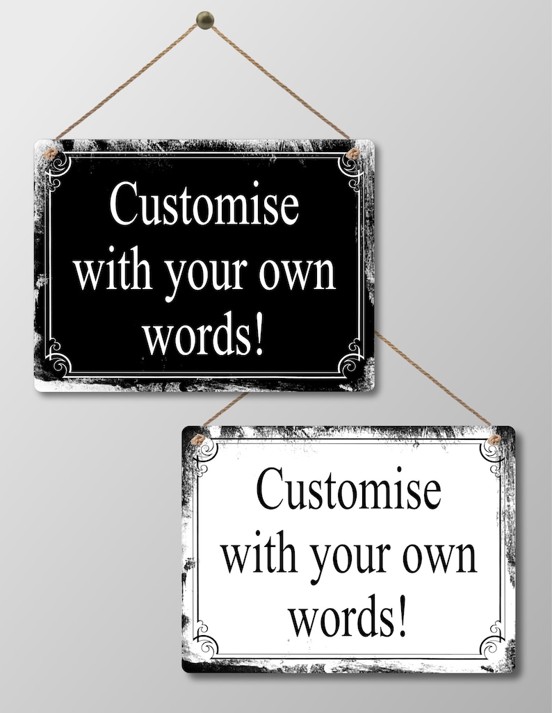 May include: Two rectangular signs with the text "Customise with your own words!" are displayed. One sign is black with white text, the other is white with black text. Both have decorative borders and are suspended by twine.