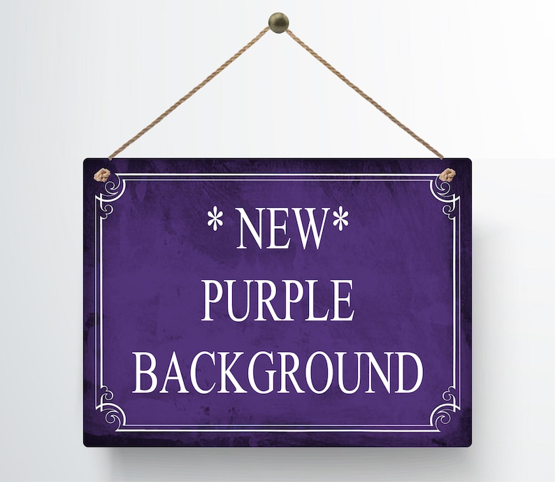 May include: A rectangular purple sign with white text that reads "*NEW* PURPLE BACKGROUND". The sign has a decorative white border and is suspended by a brown rope.