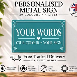 May include: A rectangular teal metal sign with white text that reads YOUR WORDS, a small heart icon, and the text YOUR COLOUR &bull; YOUR SIGN. The sign features a decorative white border and four corner holes for mounting on a wall.