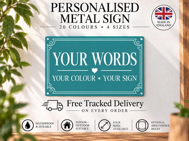 May include: A rectangular teal metal sign with white text that reads YOUR WORDS, a small heart icon, and the text YOUR COLOUR &bull; YOUR SIGN. The sign features a decorative white border and four corner holes for mounting on a wall.