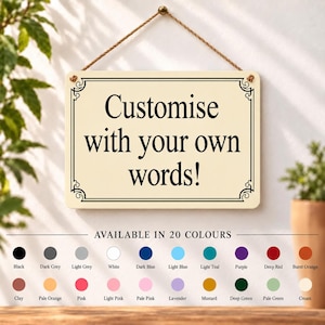 May include: A rectangular cream-coloured hanging sign with a black decorative border and the black text "Customise with your own words!". Below the sign is a colour chart displaying 20 circular colour swatches with labels including black, grey, blue, red, and green.