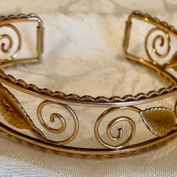 Vintage cuff bracelet signed Krementz, gold tone metal with leaves and spirals designs