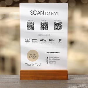 May include: A white rectangular payment sign with a wooden base featuring the text SCAN TO PAY, three QR codes for Venmo, PayPal, and Cash App, icons for Cash, Credit Card, Apple Pay, G Pay, and PayPal, a placeholder for a logo, and contact details.