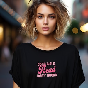 May include: A black t-shirt with a pink graphic that says "Good Girls Read Dirty Books".