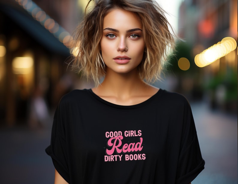 May include: A black t-shirt with a pink graphic that says "Good Girls Read Dirty Books".
