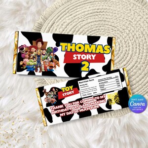 May include: Two chocolate bar wrappers with a black and white cow print design. One wrapper features the text "THOMAS STORY 2" and a Toy Story character collage. The other wrapper says "TOY STORY" and "THANK YOU FOR COMING TO MY BIRTHDAY PARTY".
